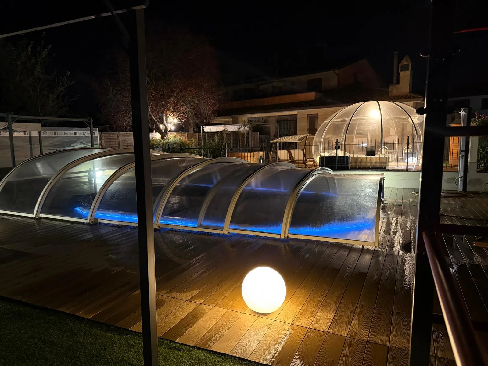 Outdoor pool at Villa Patty Assisi at night, with the lit sliding panoramic cover and the separate Bubble Jacuzzi in the background.